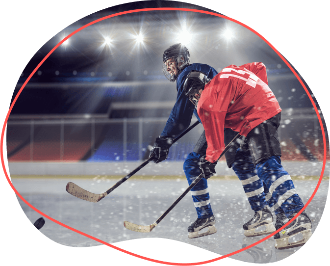 Dvaja hokejisti, jeden v modrom a jeden v červenom, zúrivo súťažia na osvetlenom klzisku a presne sa oháňajú hokejkami. Ich intenzívny boj ukazuje pravého ducha športových poukazov.